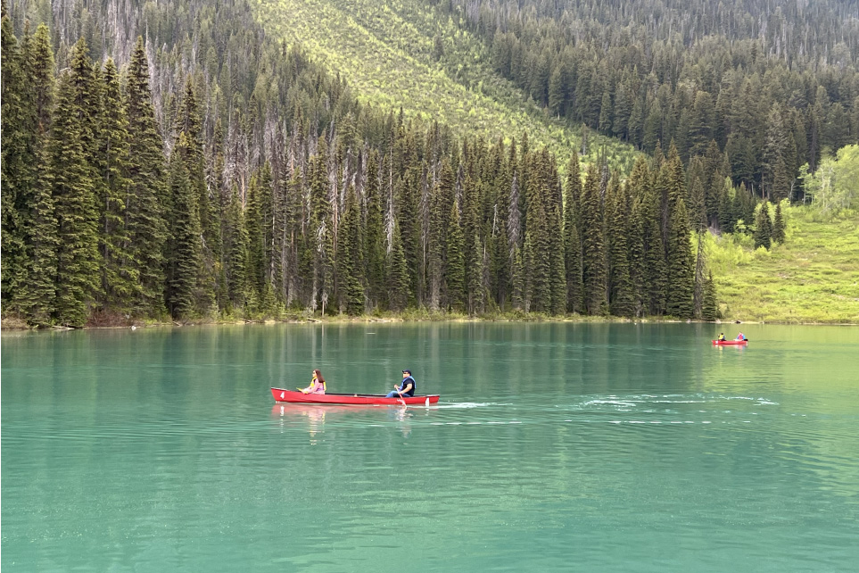 family canoeing on a lake